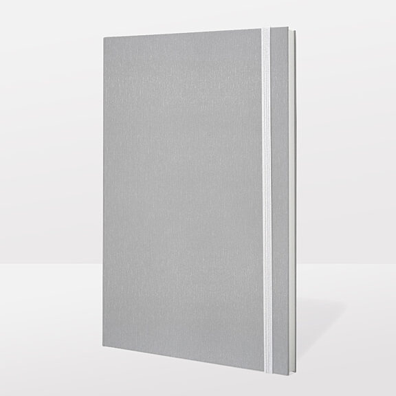Grey, slim notebook with thin, white ribbon and lined pages