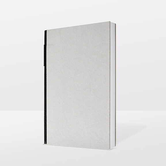 Minimalist grey notebook with black binding edge and textured surface