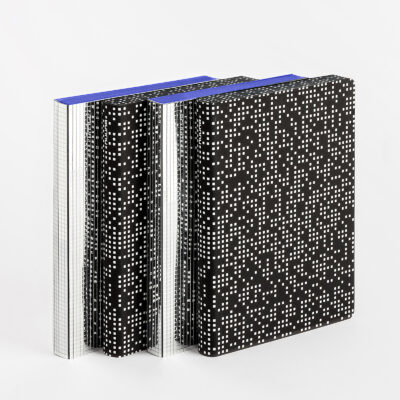 Black notebooks with white dot pattern and blue spine
